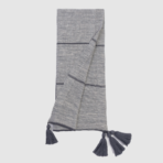 Grey knitted scarf with dark horizontal stripes and tassels at the ends