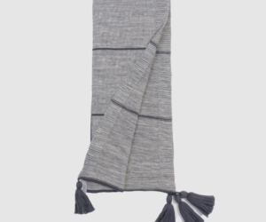 Grey knitted scarf with dark horizontal stripes and tassels at the ends