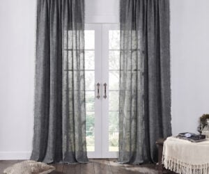 Gray sheer curtains frame white french doors letting in soft outdoor light