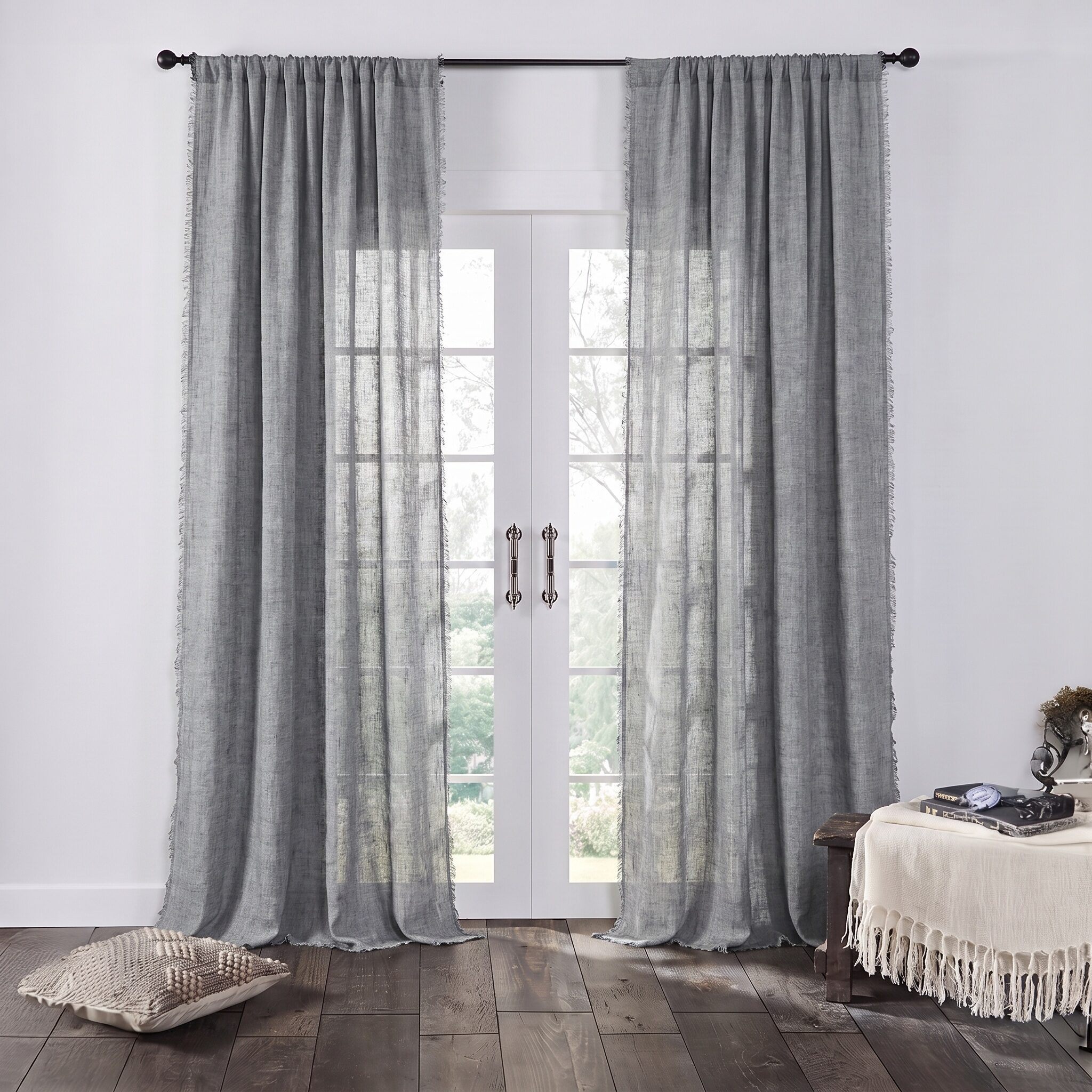 Kentlinenreversiblecurta117171 2 | Amity Home Tall white framed french doors with sheer gray curtains allowing light to filter in view of greenery outside