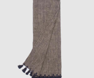 Brown knitted scarf with black tassel fringe along the ends
