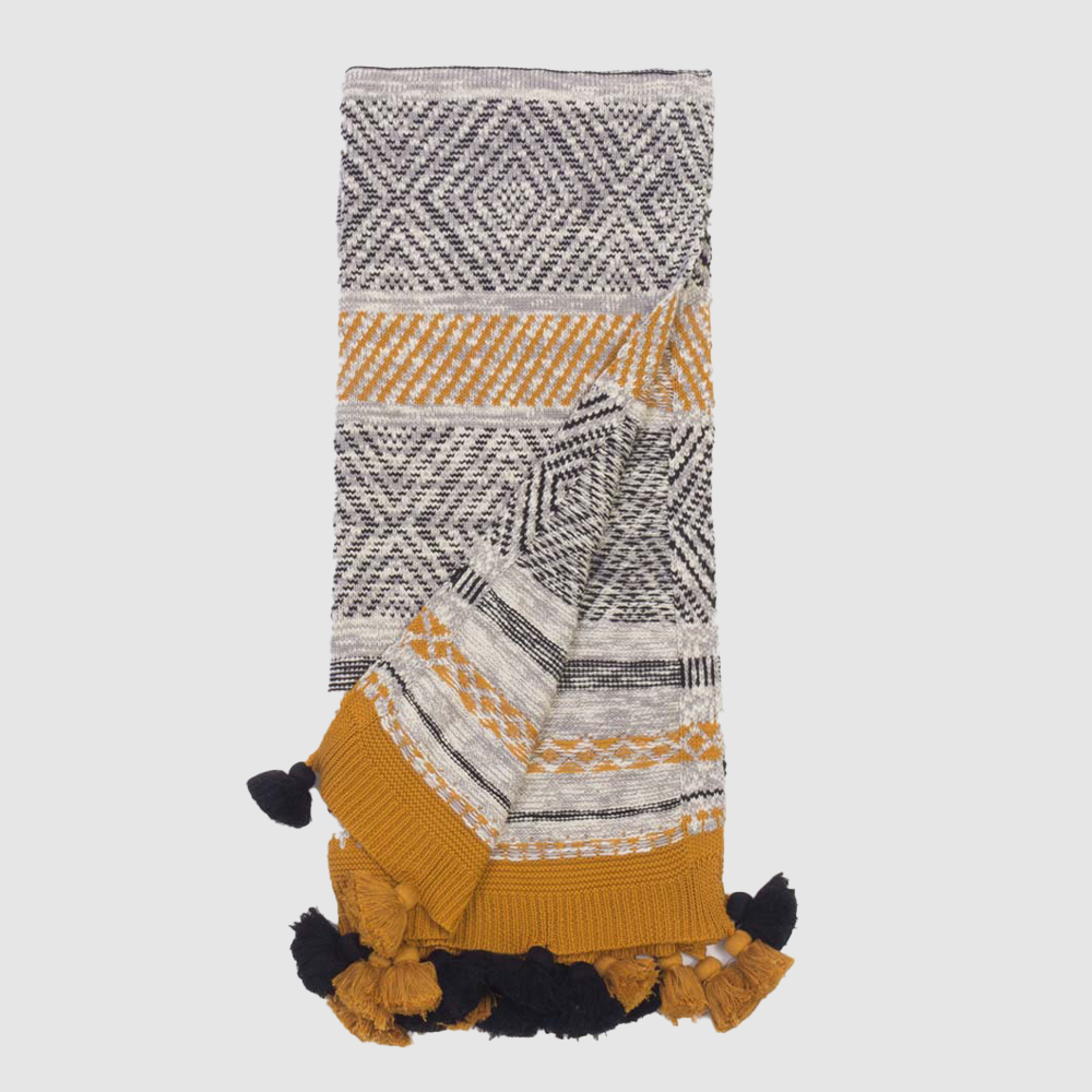 Kd2031th | Amity Home Woven throw blanket with black white and mustard geometric patterns and navy tassels along the edges
