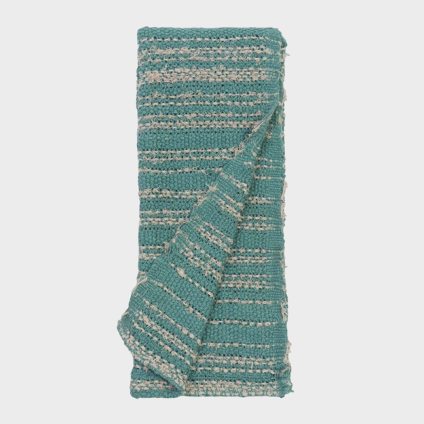 Teal woven textile folded with cream stripes and fringe along the edges, likely a towel or throw blanket.