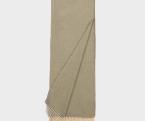 Beige scarf with fringed ends laid flat showing a simple woven texture and neutral color