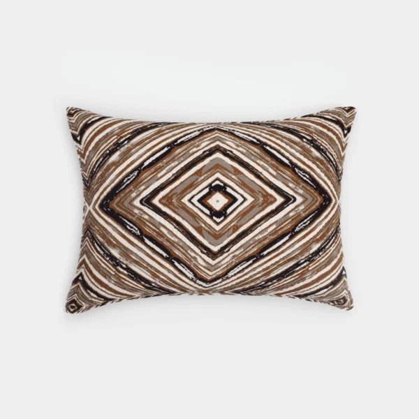 Close up of a decorative square pillow with a brown black and white geometric diamond pattern on a white background