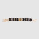 Long woven beaded bracelet with black beige and gold strands and tassels at both ends