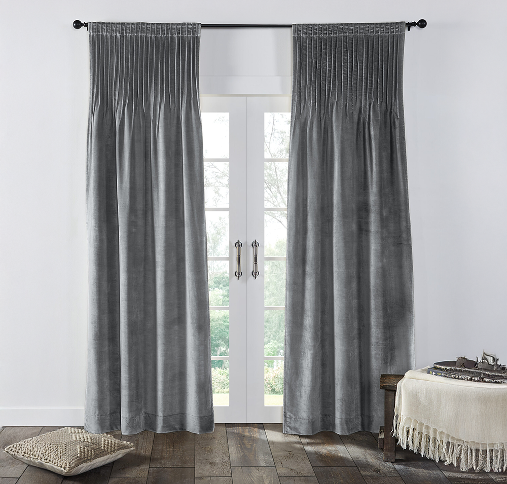 Cm15380sb | Amity Home Gray velvet curtains frame white french doors with a view of greenery outside a woven floor pillow sits nearby and a fringed throw rests on a bench to the right