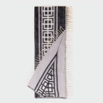 Geometric black and white scarf with fringed edges folded to display the pattern
