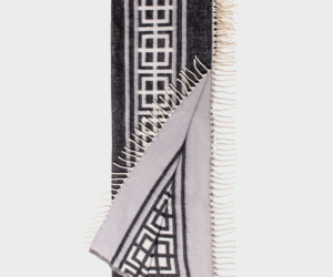 Geometric black and white scarf with fringed edges folded to display the pattern