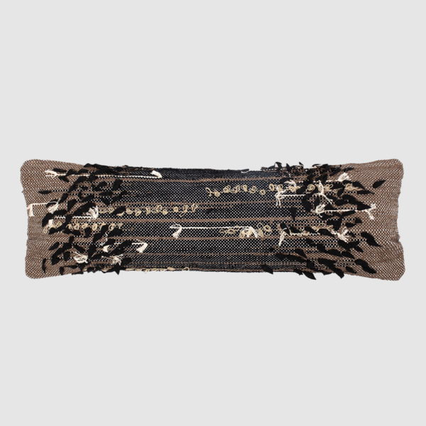 Decorative rectangular sequin pillow with black and beige reversible sequins laid flat on a light gray background