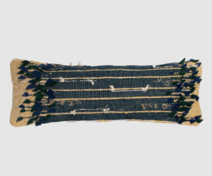 Decorative woven textile runner with navy blue and beige stripes and leafy blue green fringe along the edges