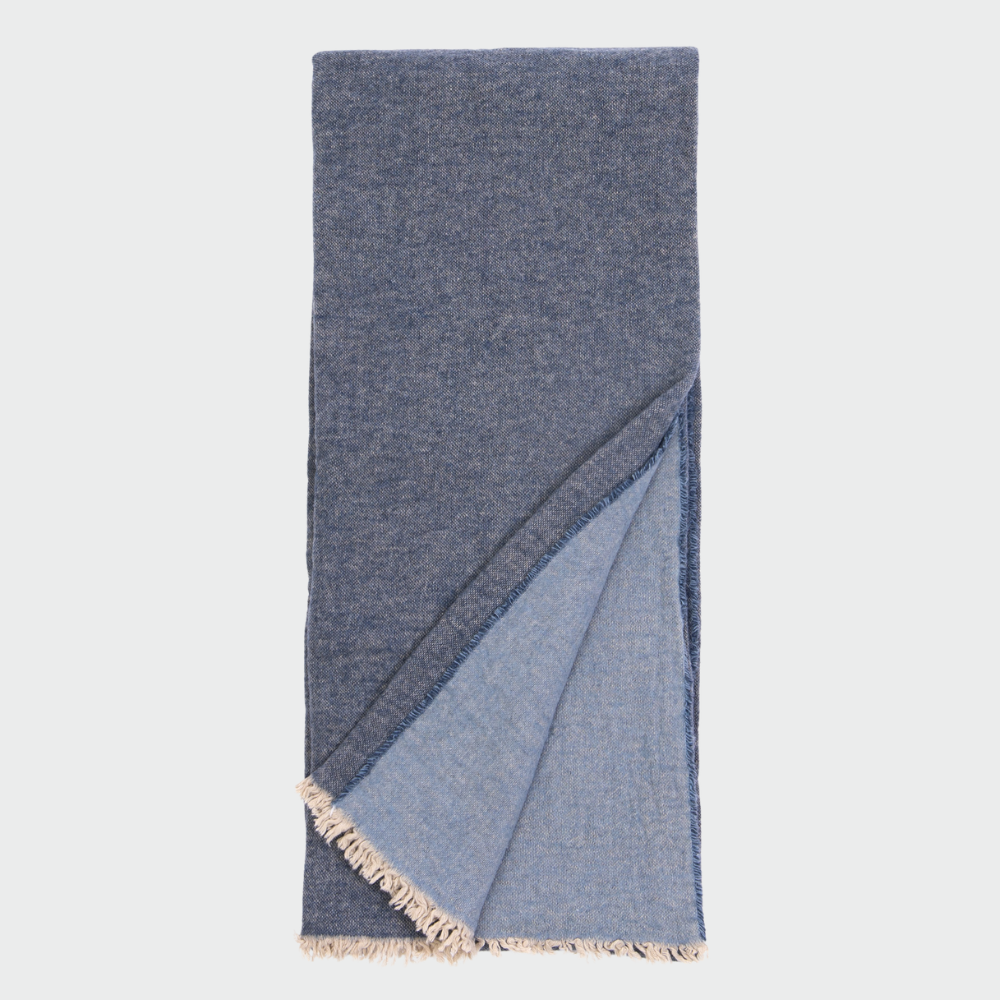 Vd101nsth | Amity Home Folded blue denim scarf with light fringe along the ends shown against a light background