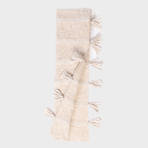 Beige woven scarf with tassels along the edges folded in a narrow strip