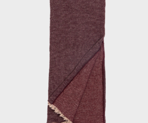 Maroon woven scarf folded with fringed ends visible at the bottom edge