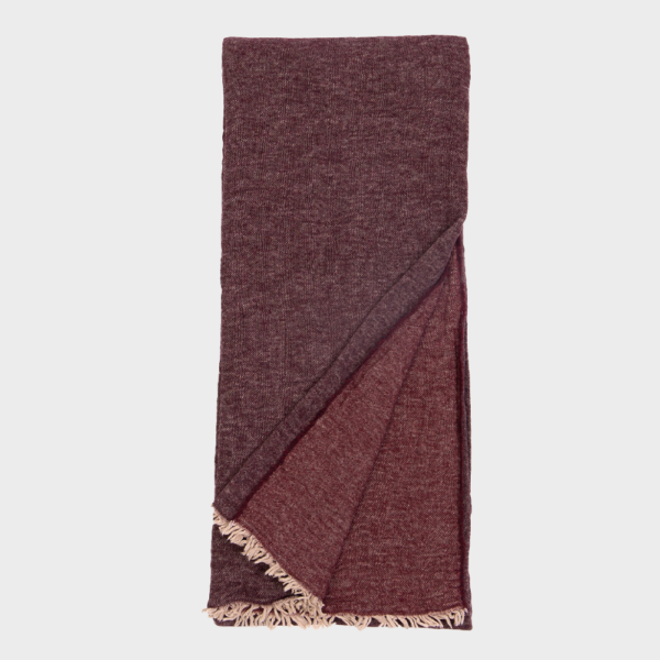 Maroon woven scarf folded with fringed ends visible at the bottom edge.