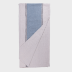 Folded light gray blanket with a blue vertical stripe panel and white striped edges
