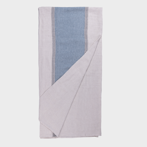 Folded light gray blanket with a blue vertical stripe panel and white striped edges.