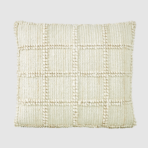 Cream square throw pillow with a chunky knit grid pattern and pom pom trim