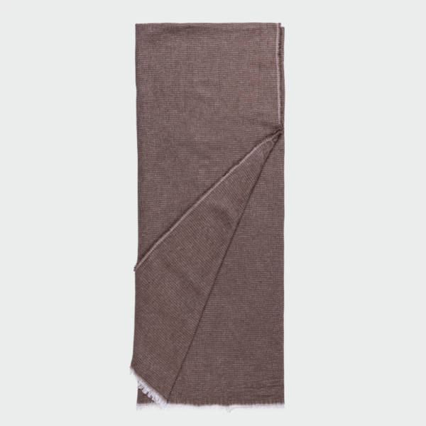 Brown woven scarf folded lengthwise with a diagonal overlap and fringed edge at the bottom corner on a light background.