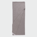 Light gray knit scarf folded flat with fringed edges visible at the bottom corner