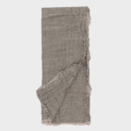 Folded light gray scarf with frayed edges laid flat against a pale background