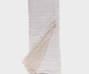 Two tone scarf with a light gray textured front and beige underside fringed edges