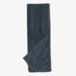 Dark blue corduroy belt laid flat with a crossed strap at the bottom