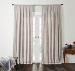 Light gray drapes covering french doors in a bright living room setting