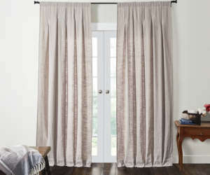 Light gray drapes covering french doors in a bright living room setting