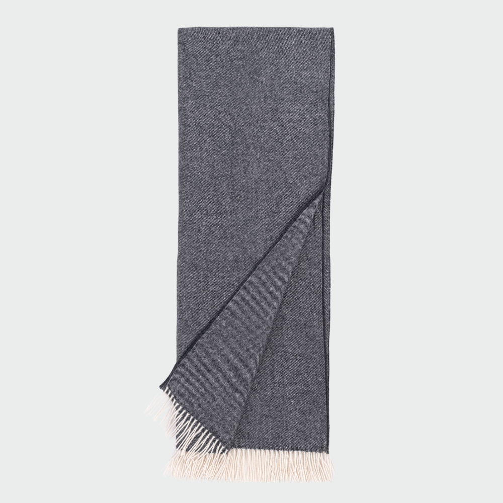 Daly Charcoal Super Throw 100 Wool | Amity Home Dark gray woven scarf with light fringed ends folded with one corner pulled over