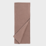 Dusty rose blanket folded showing stitched edge along the border