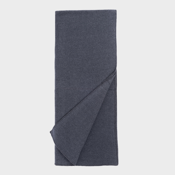 Navy blue towel folded flat with one corner folded over to show the edge stitching
