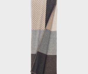 Color blocked scarf in beige gray and brown tones folded with visible stitched edge or hem