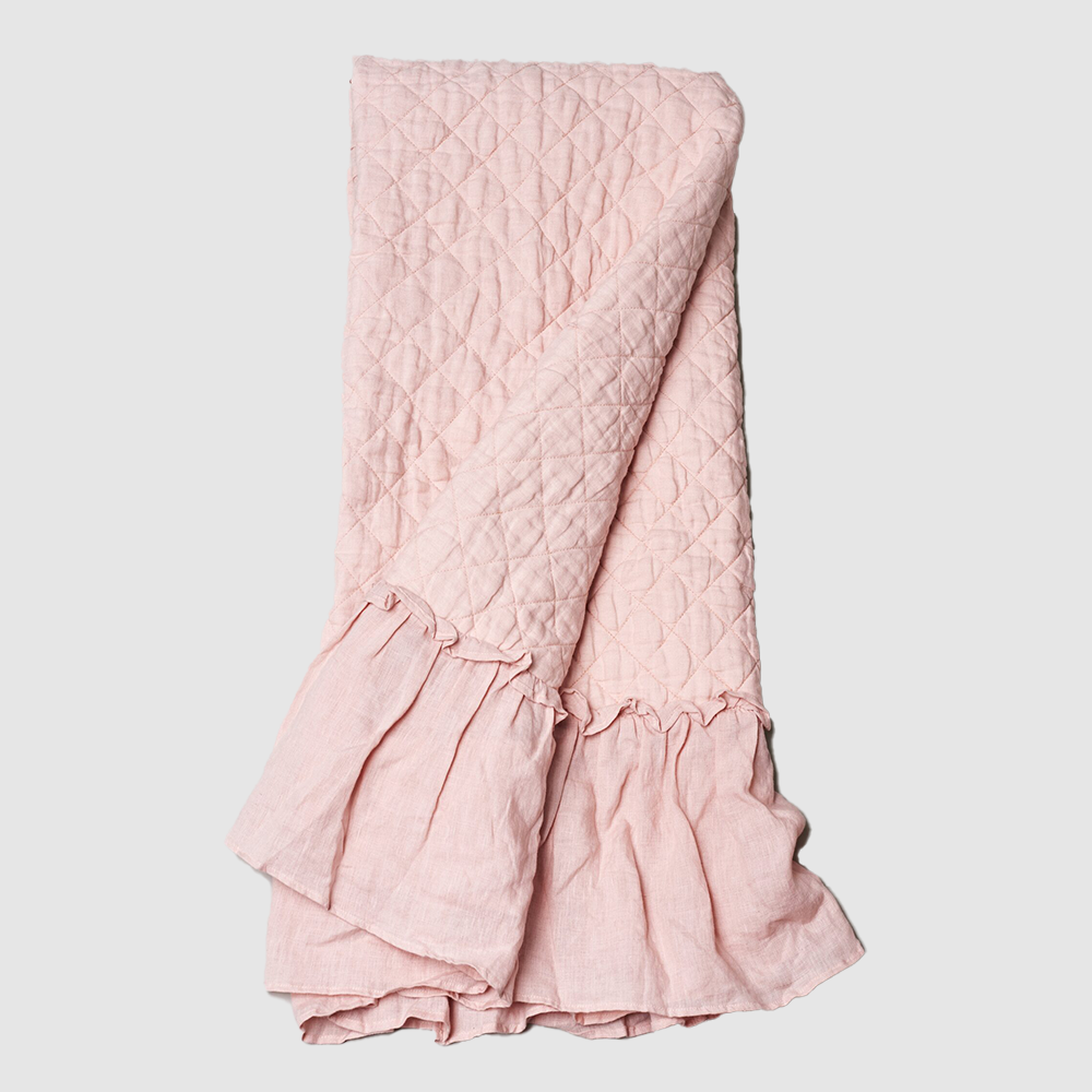 Bc815p | Amity Home Pink quilted blanket with diamond stitching and a gathered ruffle at the edge folded throwblanket