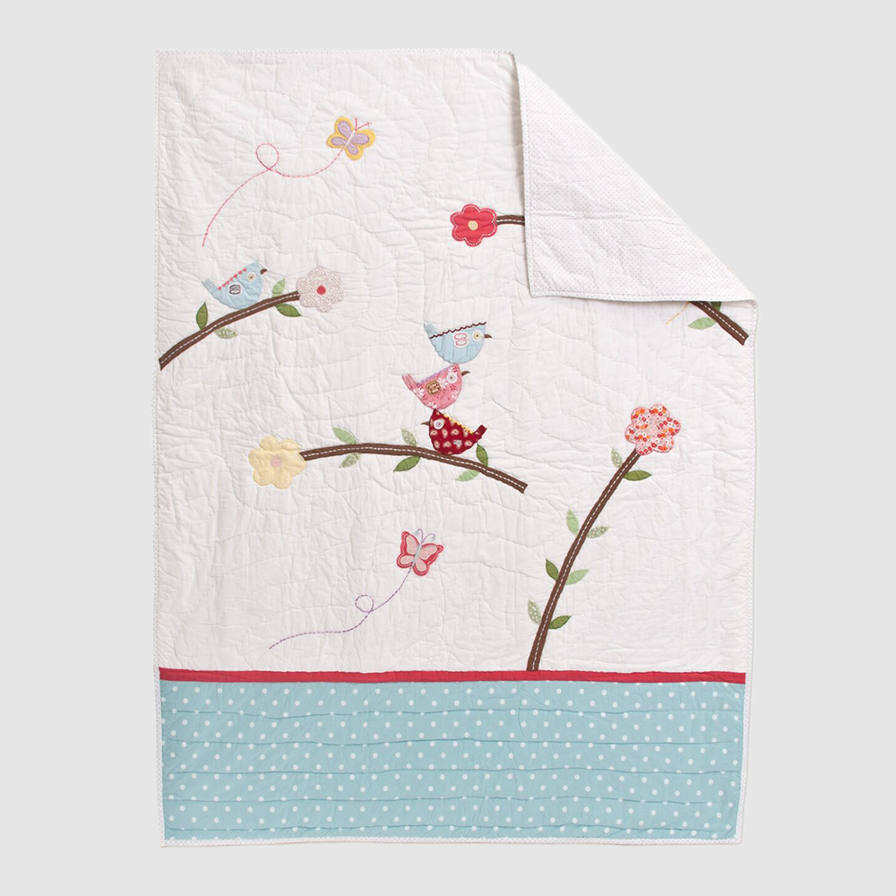 Cc802 | Amity Home Decorative quilt with pastel birds on branches colorful flowers and a blue polka dot border on a white background