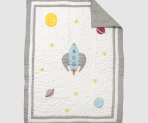 Space themed quilt with a blue rocket at center yellow stars sun and planets on a white field with a gray border