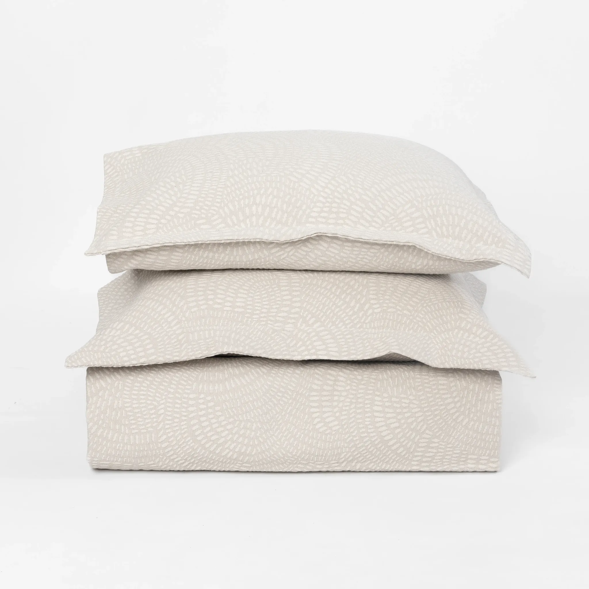 Tr1031nmal6 | Amity Home Stack of three cream colored pillows with a subtle geometric pattern on a white background