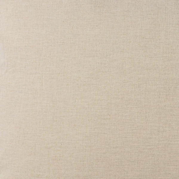 Close up of beige woven linen fabric texture with visible fibers and weave pattern
