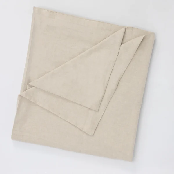 Beige linen fabric folded into layered panels on a white background