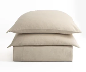 Three beige pillows stacked on a white background