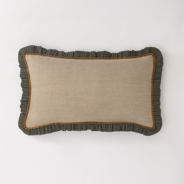 Beige throw pillow with brown edging and a dark green plaid ruffle border on a white background.