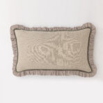 Beige decorative cushion with a brown and white gingham ruffle trim along the edges on a white background