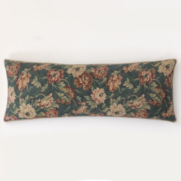 Decorative floral cushion along the bottom edge of a white wall.