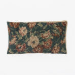 Decorative throw pillow with dark green fabric and large pinkish brown floral print beige trim informative