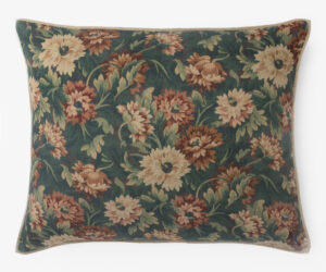 Decorative cushion with a dark green background and pink beige floral pattern bordered by a light beige trim