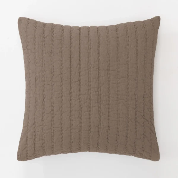 Brown textured throw pillow with vertical stitched seams on a white background shown close up from above