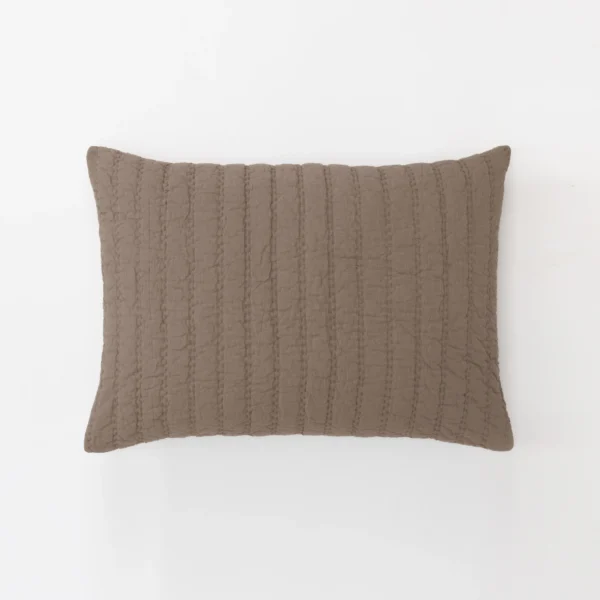 Partial view of a brown quilted throw pillow on a white background