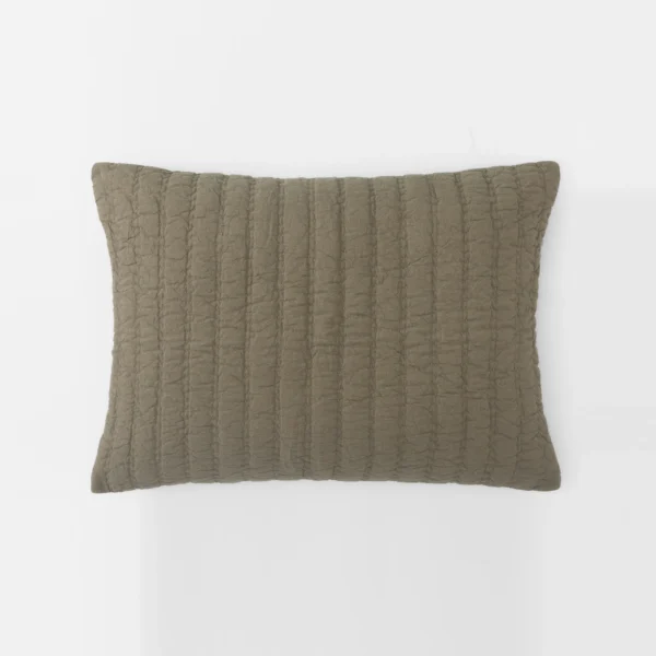 Brown quilted cushion with vertical stitched pattern on a white background viewed from the top edge edge