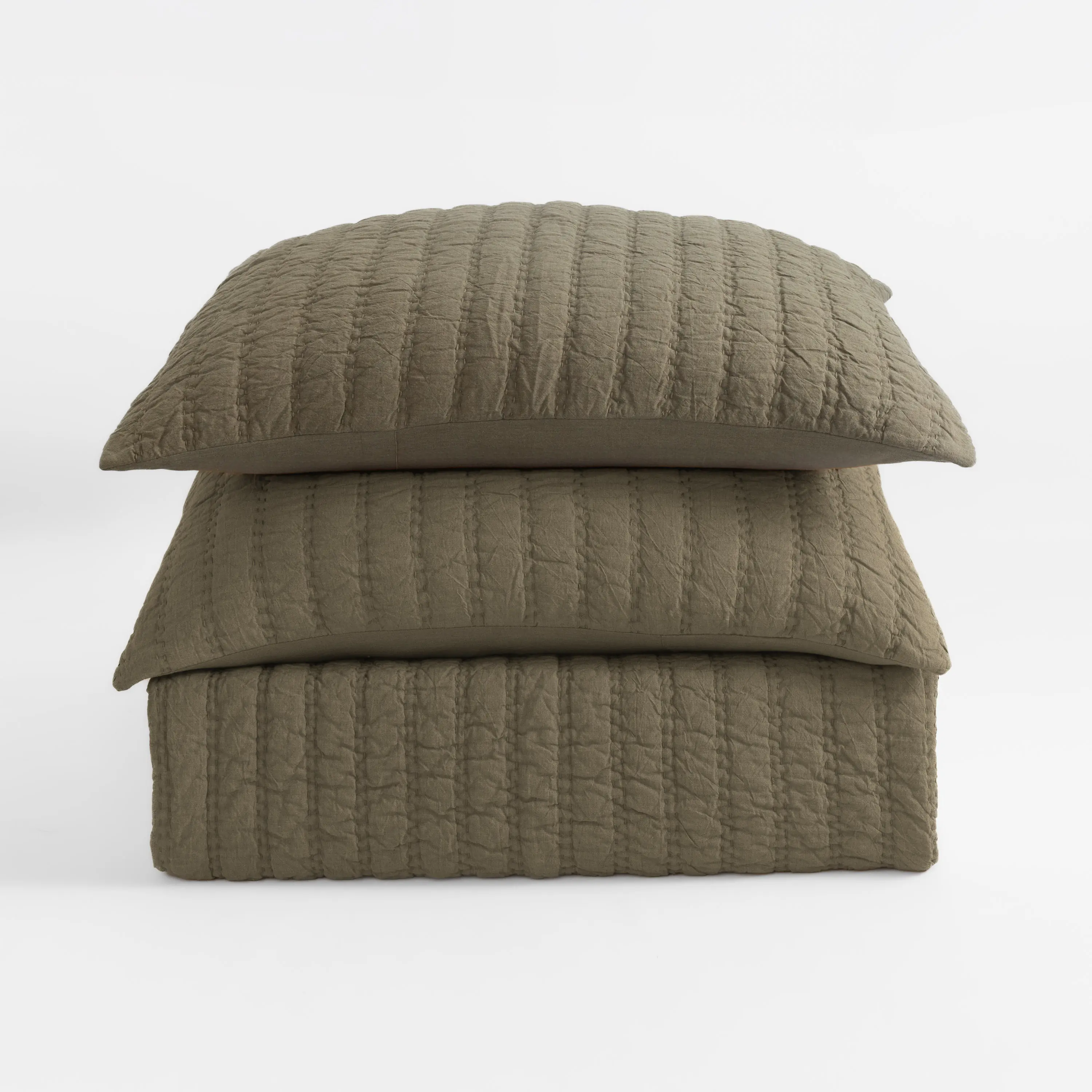 Cc1154lstk32 | Amity Home Stack of three beige quilted pillows with vertical stitching on a white background