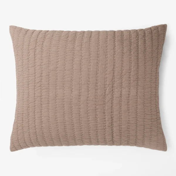 Brown quilted throw pillow with vertical stitching on a white background